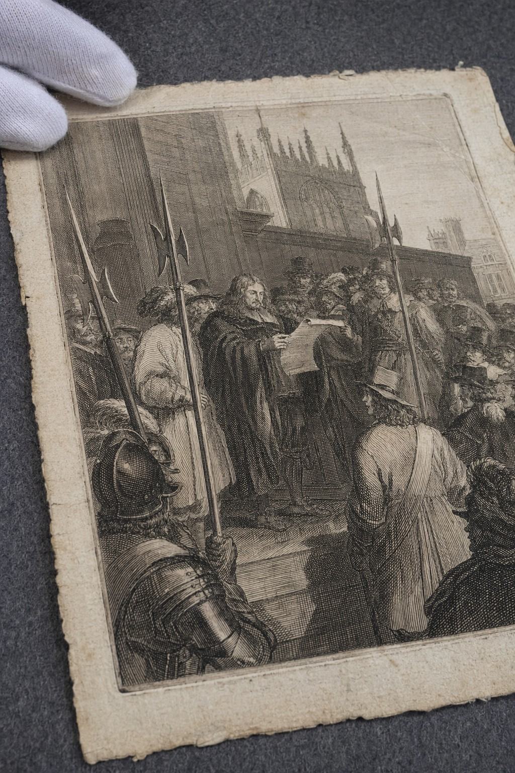 Archival reproduction photograph of a 1686 English copperplate engraving on laid paper depicting the proclamation of the Declaration of Tolerance before Parliament; oblique angle from above left on a gray felt board; raking light emphasizing plate mark, chain lines, slight foxing, and frayed deckle edge; tight crop excludes any printed captions or lettering; scene shows a clerk reading from a scroll as halberdiers and onlookers lean in, with dense crosshatching and stipple typical of a London workshop; a conservator’s cotton-gloved fingertips steady the top corner; shot on Ektachrome 100 with fine grain; 60mm macro lens on a copy-stand; no visible labels.