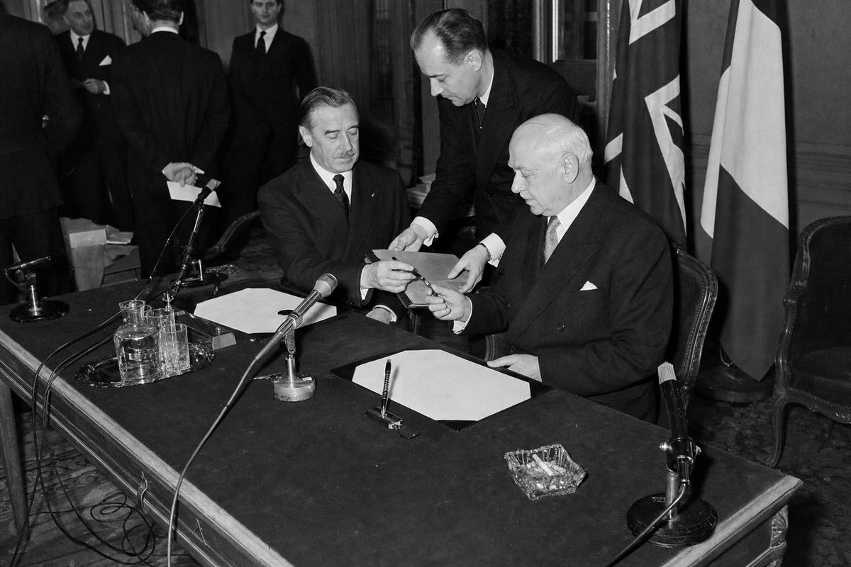 Ministers exchange pens at the Channel Defence Pact signing in Calais, 1954