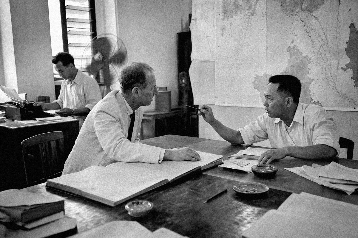 Inside the Harbour Board room on Light Street, two members argue across open ledgers as a clerk types in the corner.