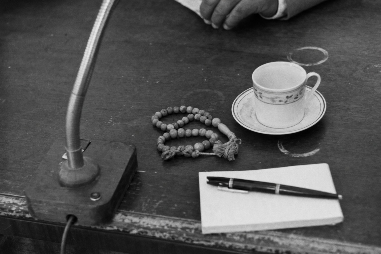 Prayer beads, teacup, microphone base, and a pen on the council table during the 1964 sessions.